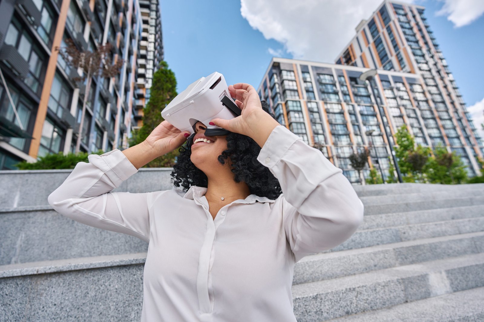 Mixed race young woman smiling in virtual reality glasses