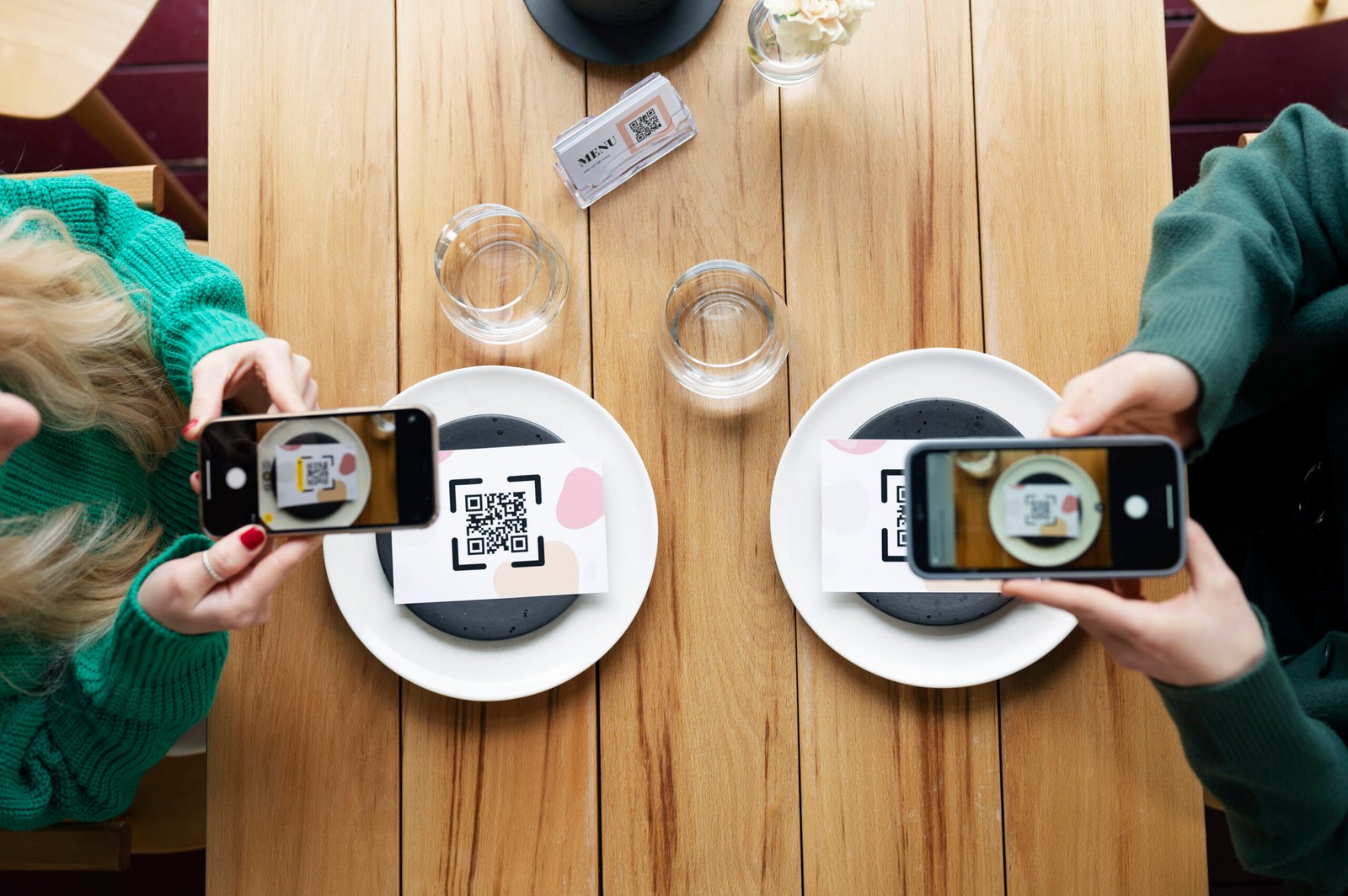 top-view-hands-scanning-qr-codes
